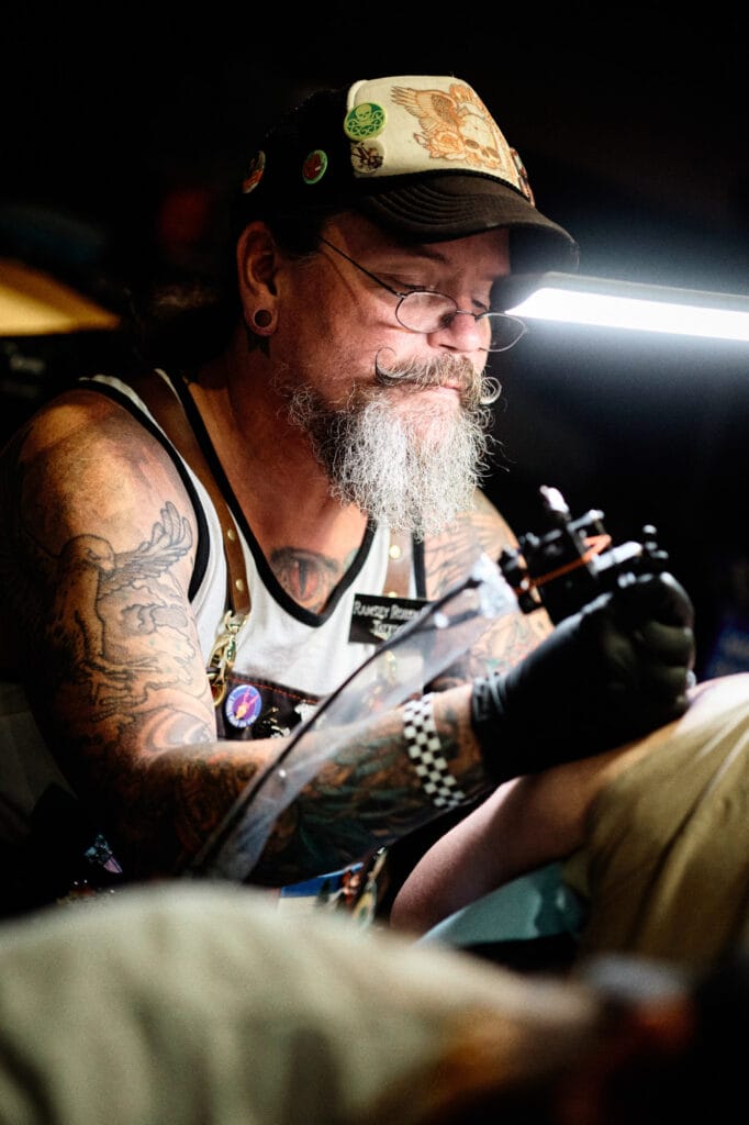 Tattoo artist focused on intricate design creation.