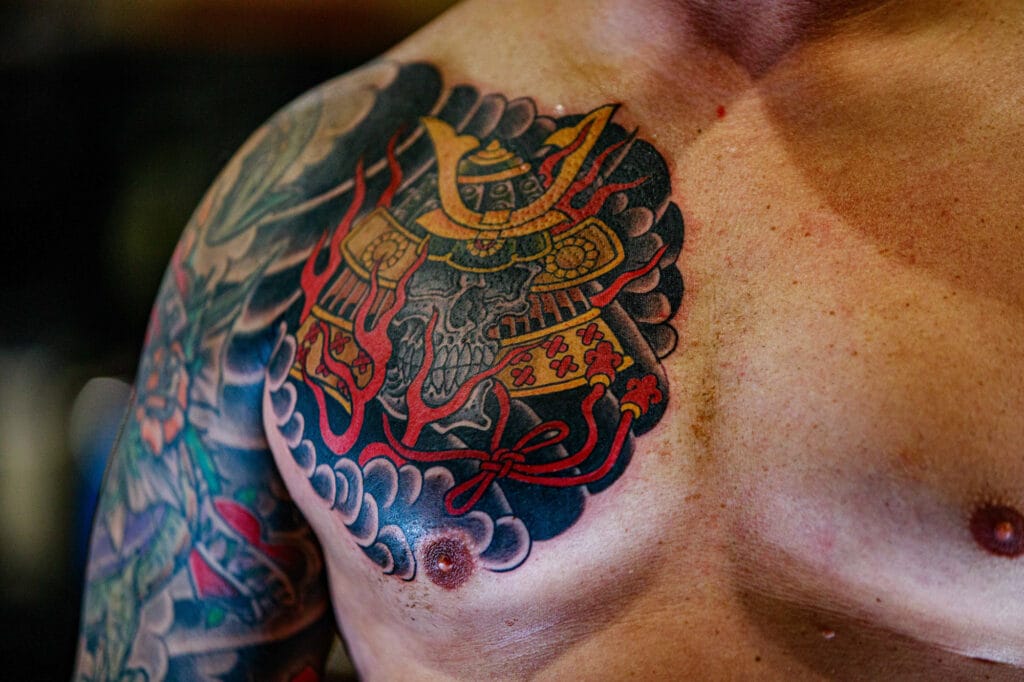 Samurai helmet tattoo on chest.