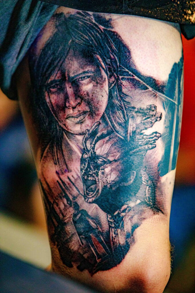 Detailed tattoo of character and monster on leg