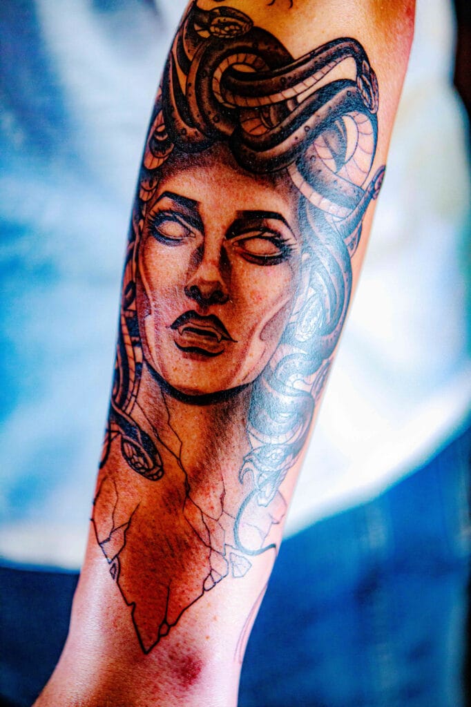 Medusa tattoo with snakes on forearm skin