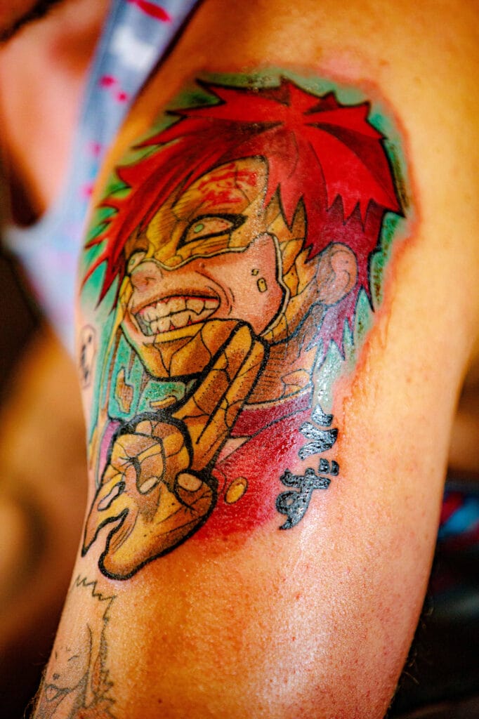 Colorful anime character tattoo on arm