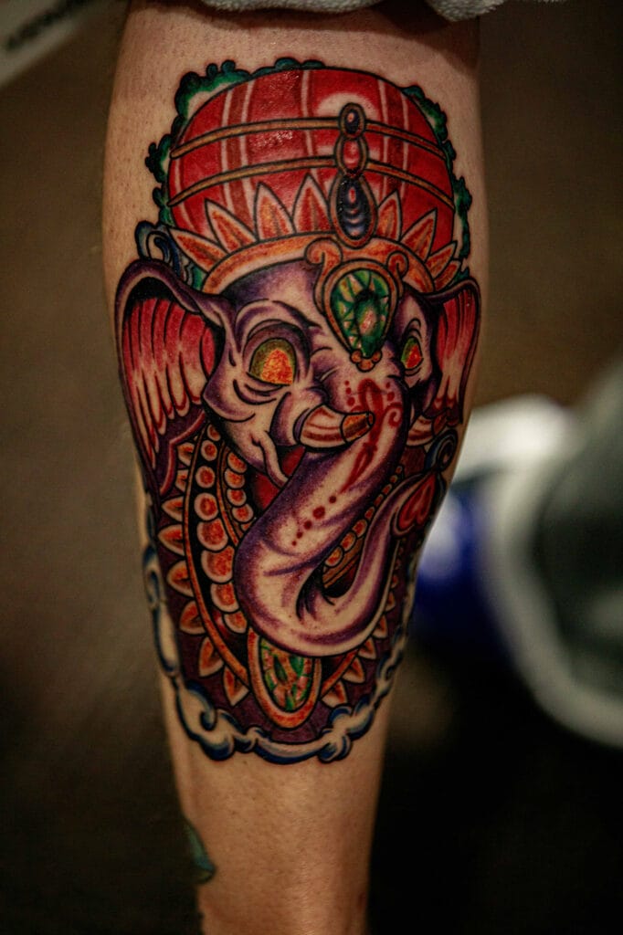 Colorful Ganesh tattoo on leg