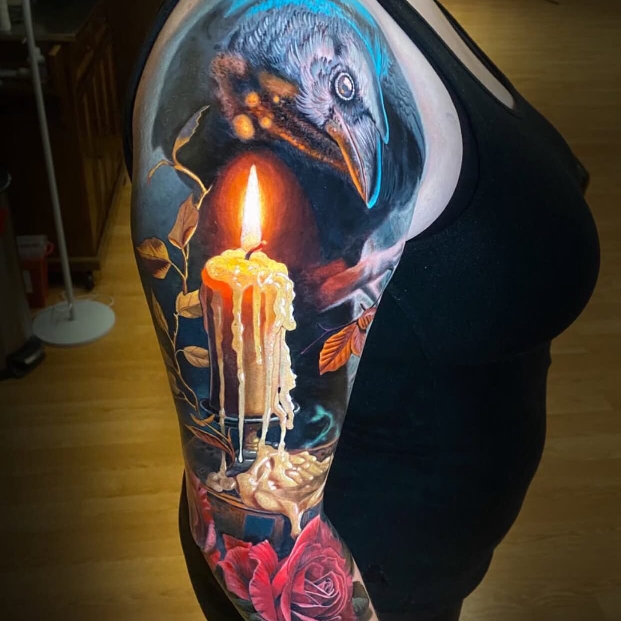 Detailed arm tattoo with candle and rose