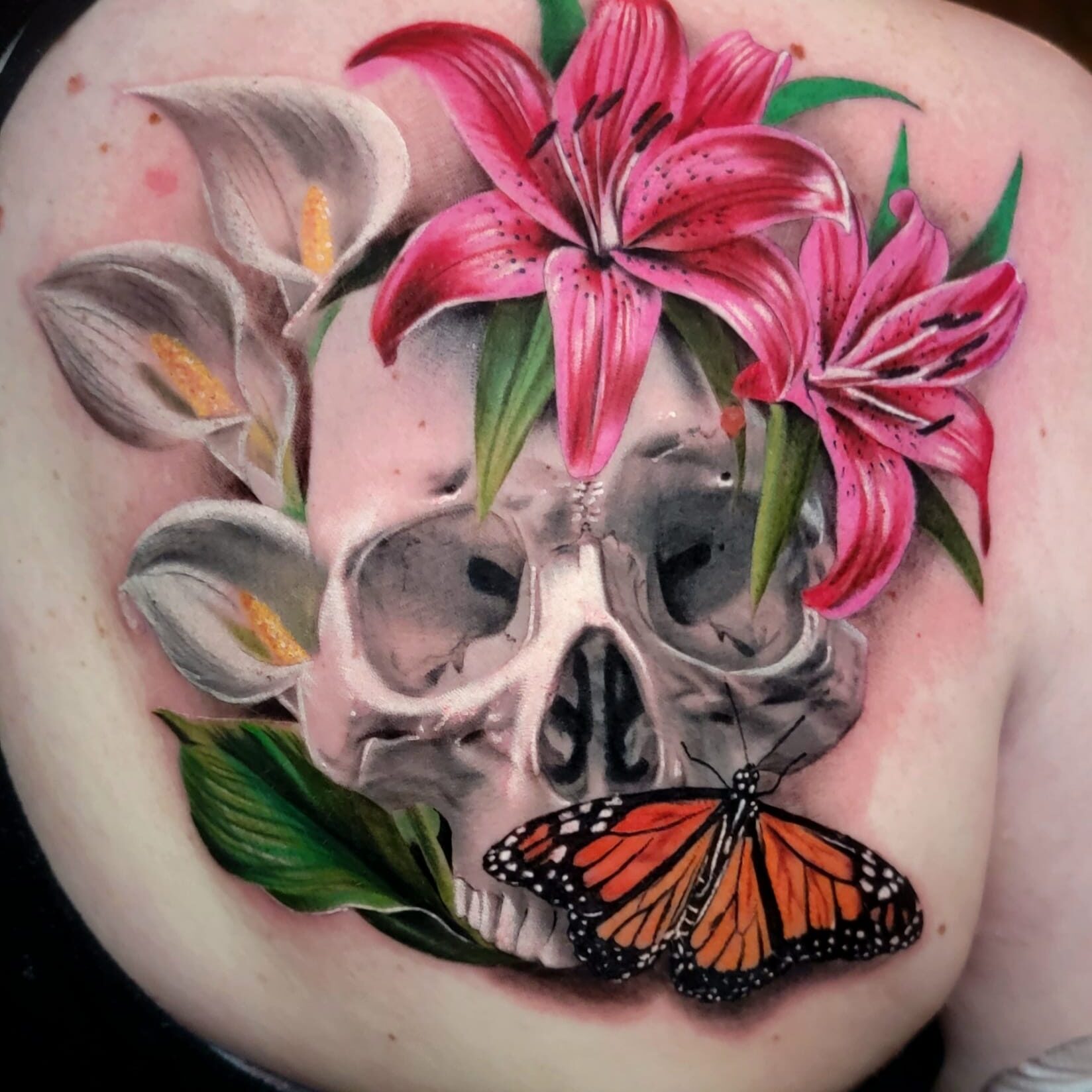 Vibrant tattoo with skull and flowers